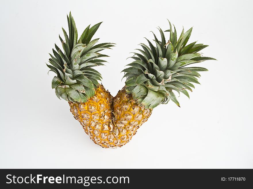 Twin ripe pineapple isolated on white background.