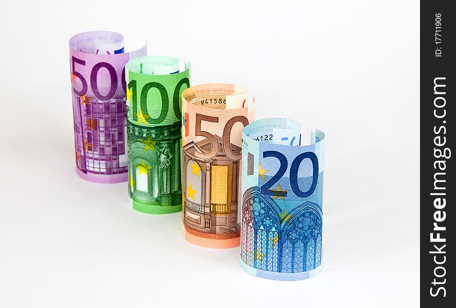 Four rolled euro banknotes on white. Four rolled euro banknotes on white.