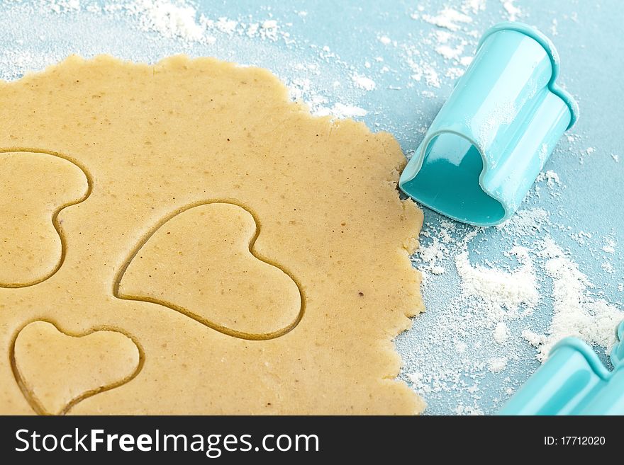 Making heart shaped shortbread cookies with cutters, dough