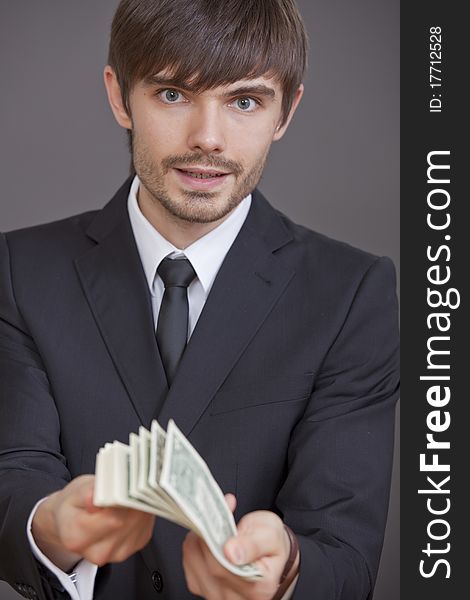 Businessman holding bunch of dollars in his hands. Businessman holding bunch of dollars in his hands