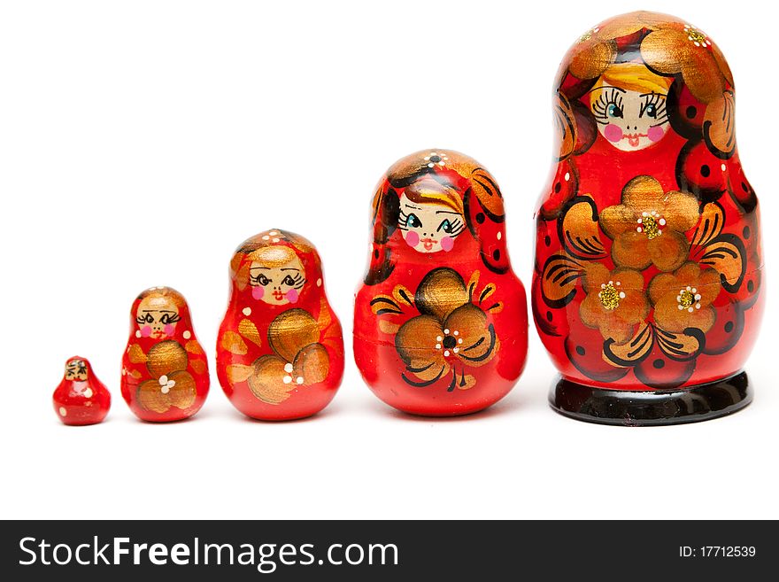 Russian nesting dolls stand in a row on a white background