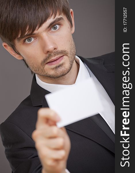 Young man showing business card in the camera. Young man showing business card in the camera