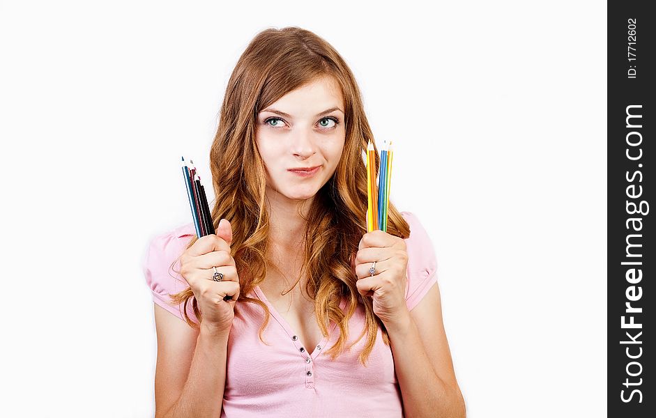 The joyful girl with color pencils on a white background