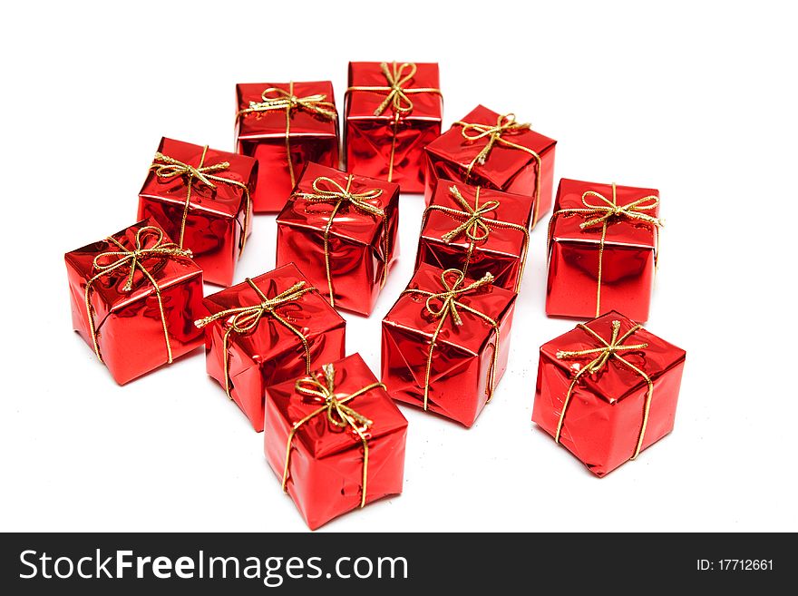 Gift red boxes with gold bows on a white background