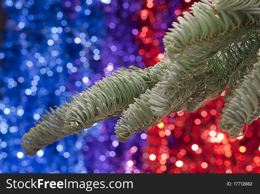 Christmas theme. Christmas tree branch against a background of Christmas decorations.