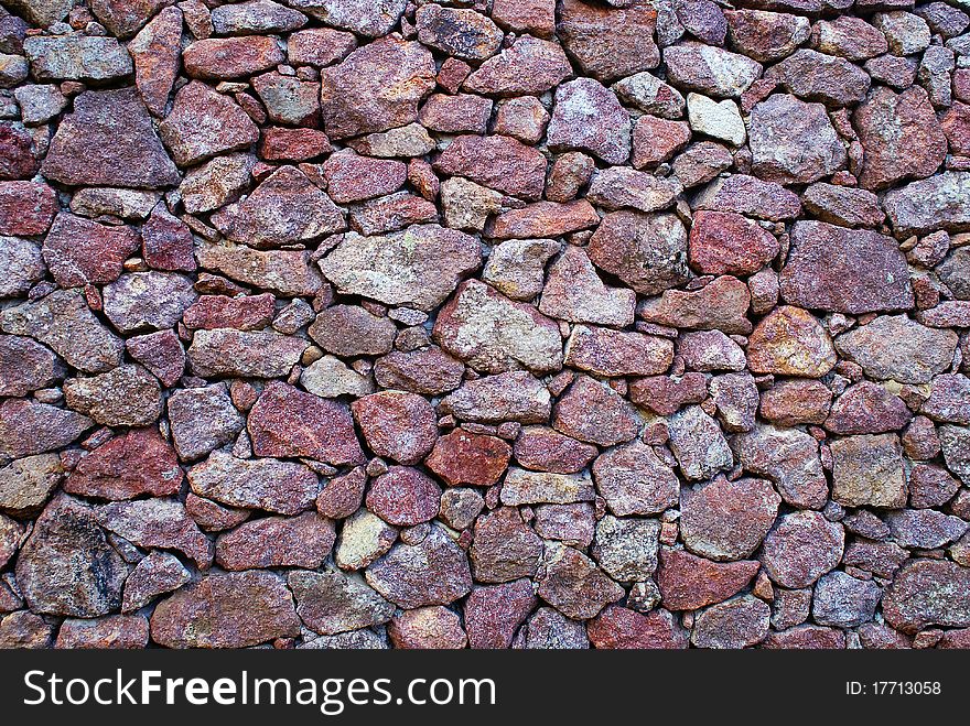 Background color of the stone wall of red and brown. Background color of the stone wall of red and brown.