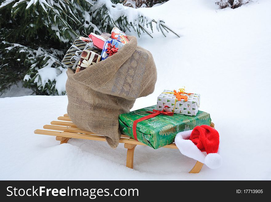 Bag of Christmas presents in the snow.