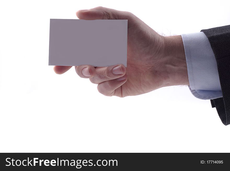 Businessman in grey suit and a blue shirt shows professional business card with copy space, shallow dept of field. Businessman in grey suit and a blue shirt shows professional business card with copy space, shallow dept of field