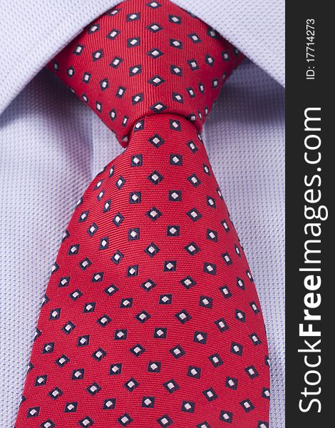Close up of a red business tie and a blue dress shirt. Close up of a red business tie and a blue dress shirt