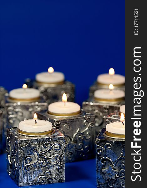 Christmas candle over blue background