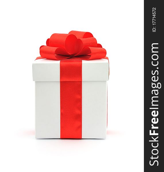 White gift box with a red bow on white background. White gift box with a red bow on white background