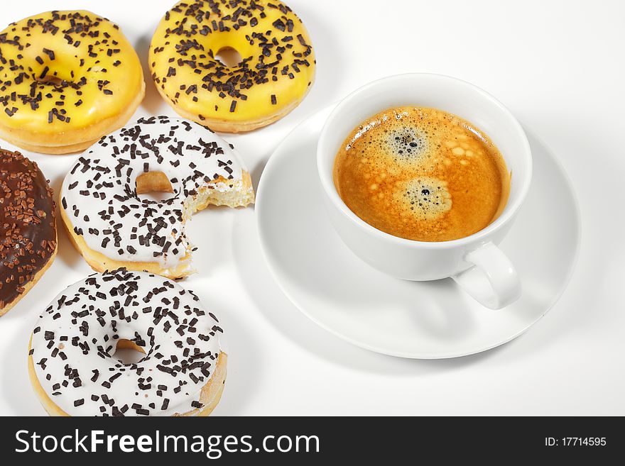 Donuts with cup of coffee on white background