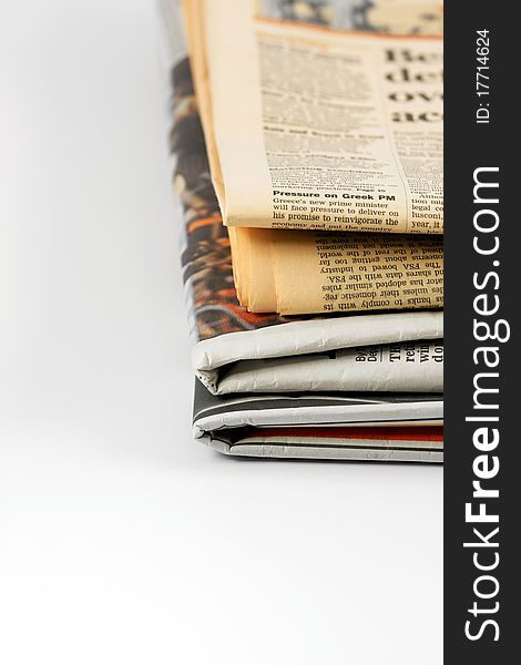 Various newspapers over white background