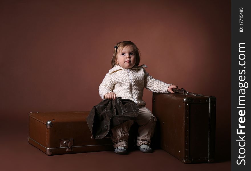 Baby with bags preparing to leave