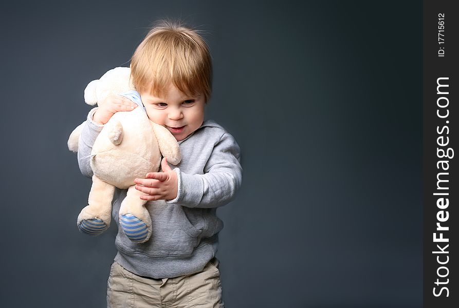 Baby gently hugging white teddybear. Baby gently hugging white teddybear