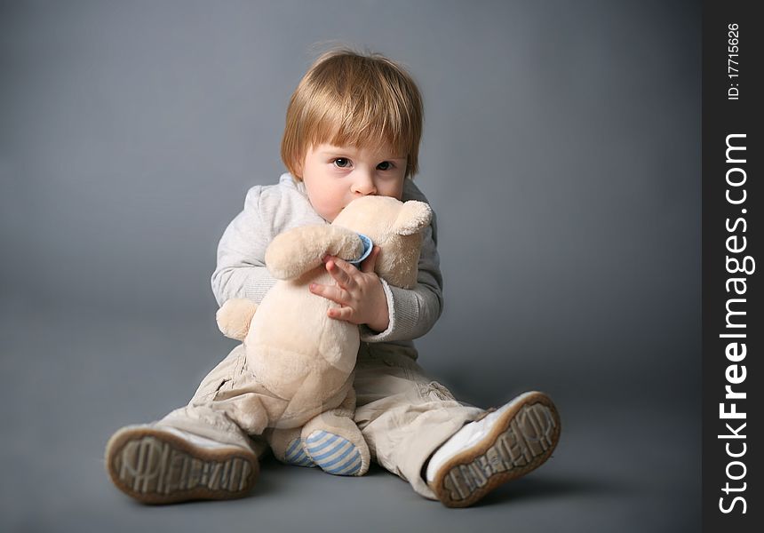 Baby gently hugging white teddybear. Baby gently hugging white teddybear