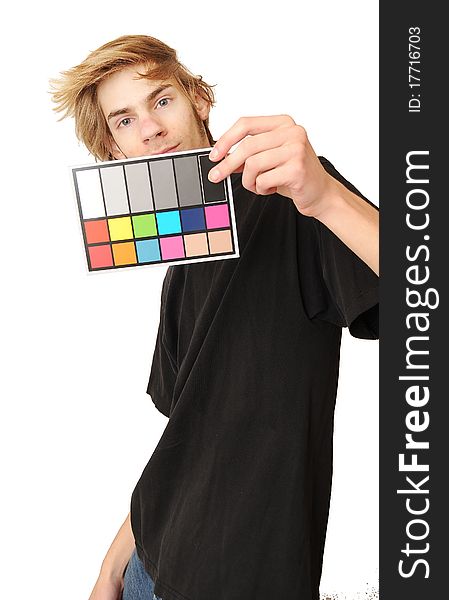 A man holds up an 18 % gray white balance card with test colors on it to calibrate the colors perfectly in post production. A man holds up an 18 % gray white balance card with test colors on it to calibrate the colors perfectly in post production.