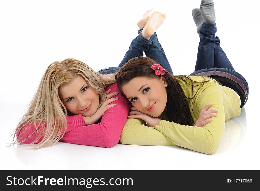 Two pretty girl friends having fun and laughing. isolated on white background