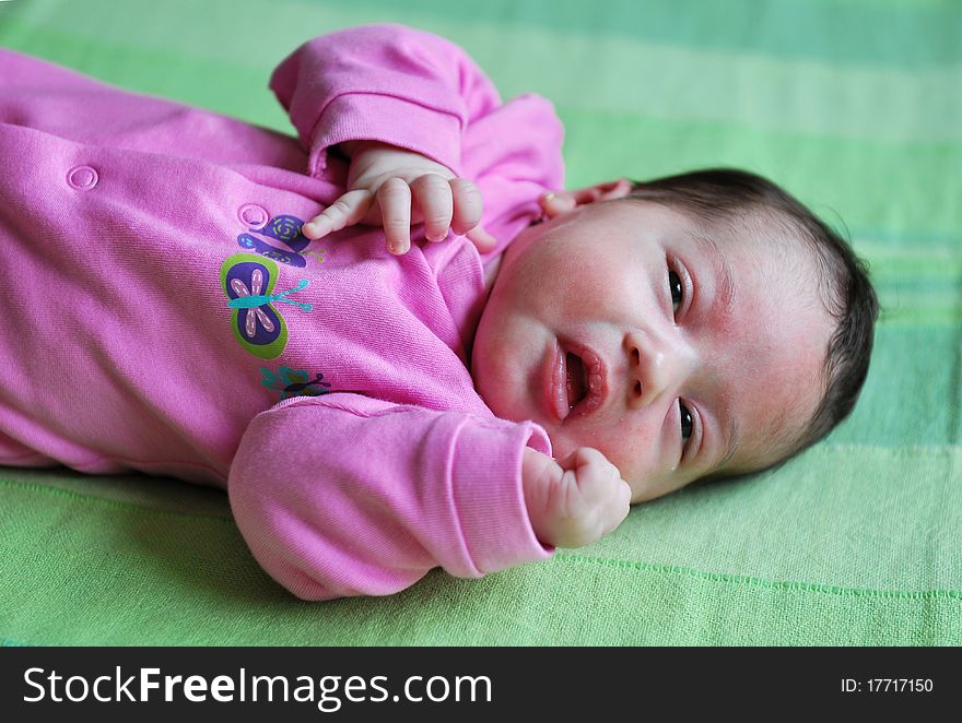 Portrait with beautiful baby girl of 21 weeks old awake