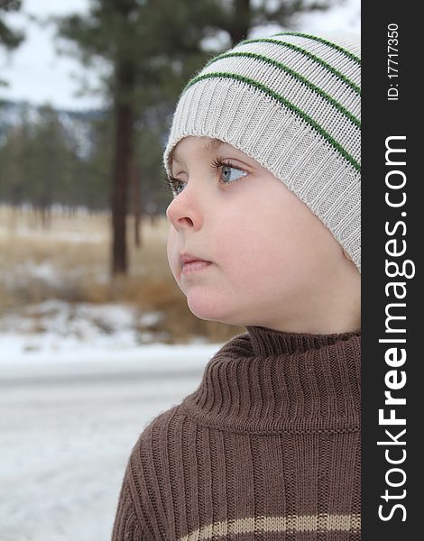 Warmly dressed boy playing outside in the snow. Warmly dressed boy playing outside in the snow