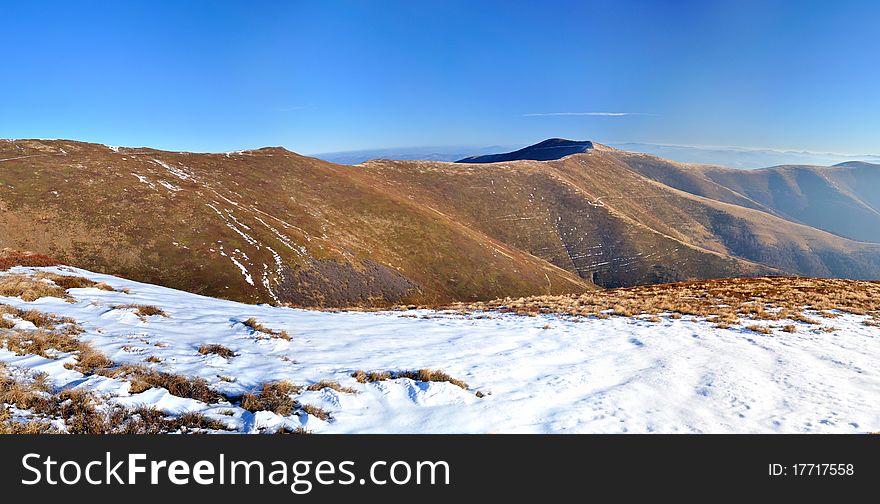 Mountain ridge and first snow panorama. Carpathians. Ukraine. Zakarpattya