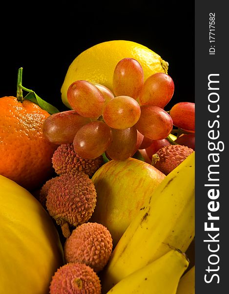 Selection of tropical fruits on a black background