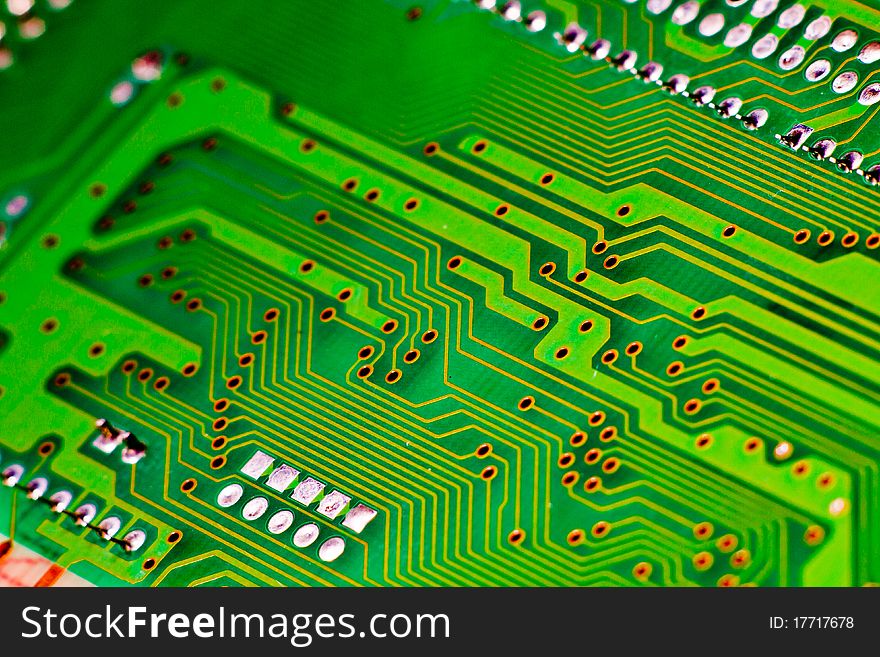 Green and yellow circuit board of computer components in electronic device. Green and yellow circuit board of computer components in electronic device