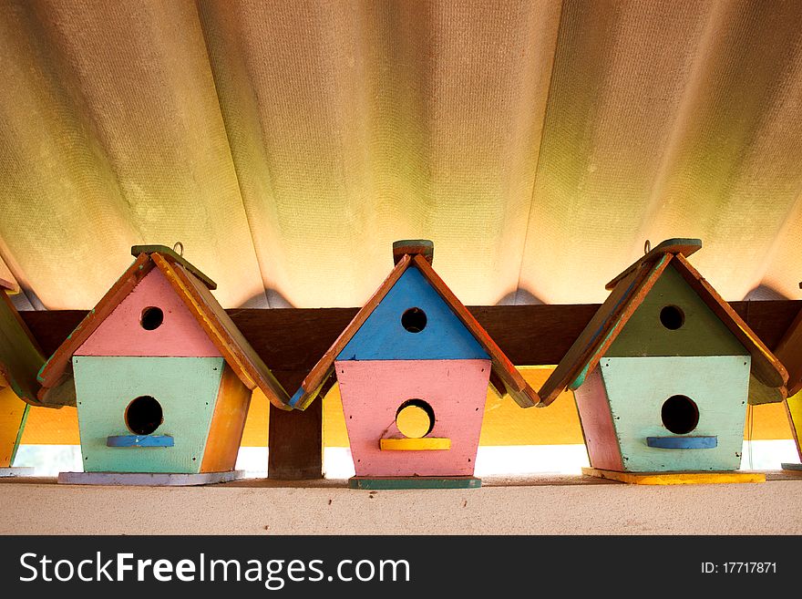 Colorful bird houses under the roof