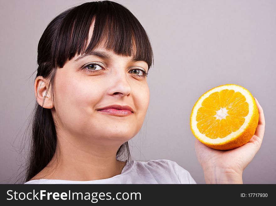 Attractive caucasion girl with two orange in hands. Artistic selective focus. Attractive caucasion girl with two orange in hands. Artistic selective focus.