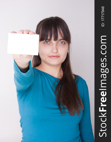 Attractive caucasion girl with business or gift card. Selective focus. Space for text available. Attractive caucasion girl with business or gift card. Selective focus. Space for text available.