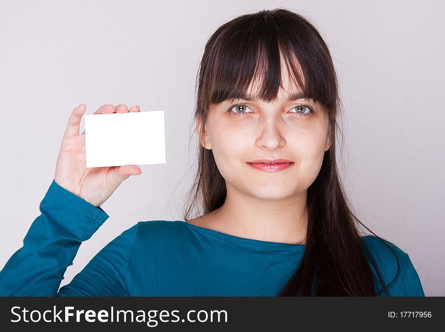 Attractive caucasion girl with business or gift card. Selective focus. Space for text available. Attractive caucasion girl with business or gift card. Selective focus. Space for text available.