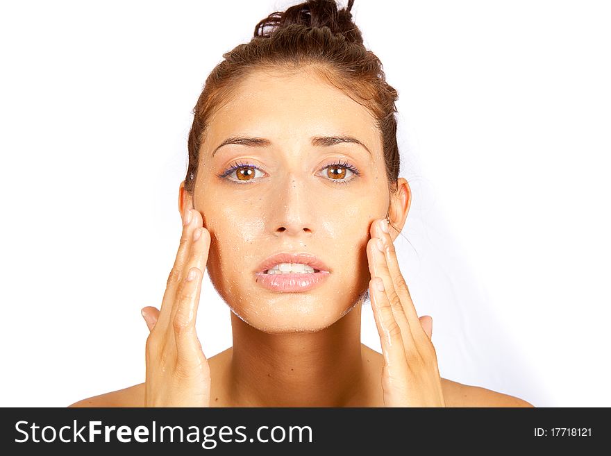 Young female cleaning her face