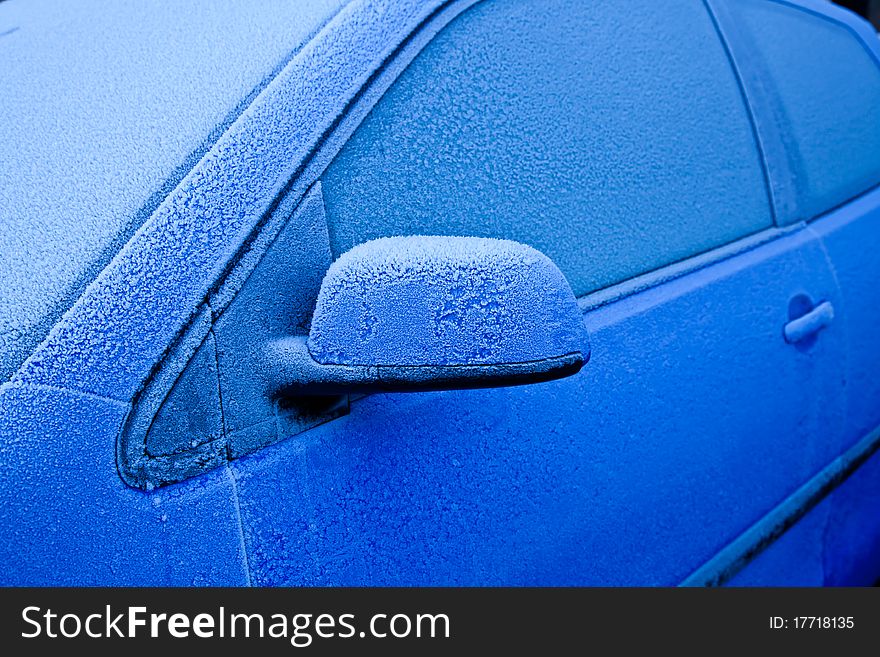 Ice on a blue car during winter season, good for concepts. Ice on a blue car during winter season, good for concepts