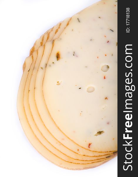 Cheese slices with spices on a white background.