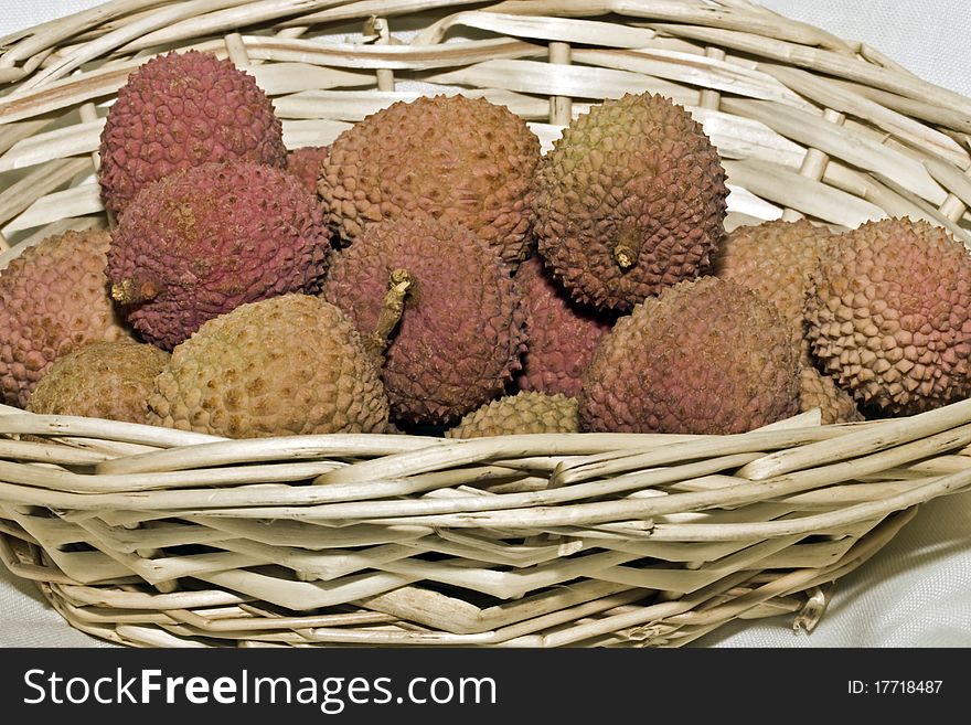 A close up of lychee fruit in a basket. A close up of lychee fruit in a basket