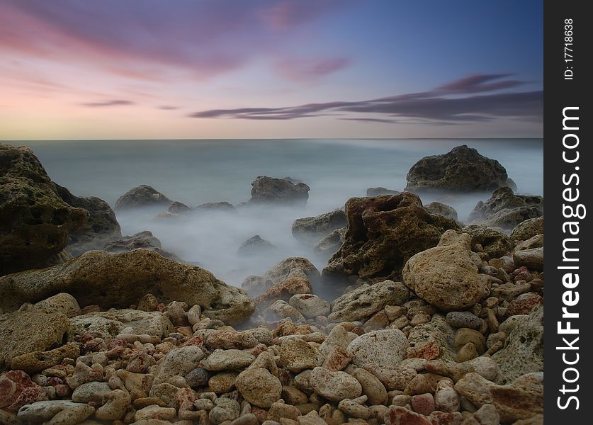 Sea coast in the summer, a sunset over the sea