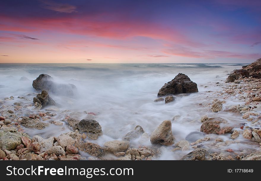 Sea coast in the summer, a sunset over the sea