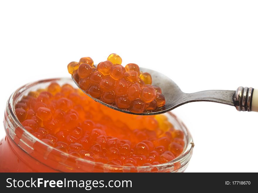 Red caviar in a spoon, salmon caviar, it is isolated on white