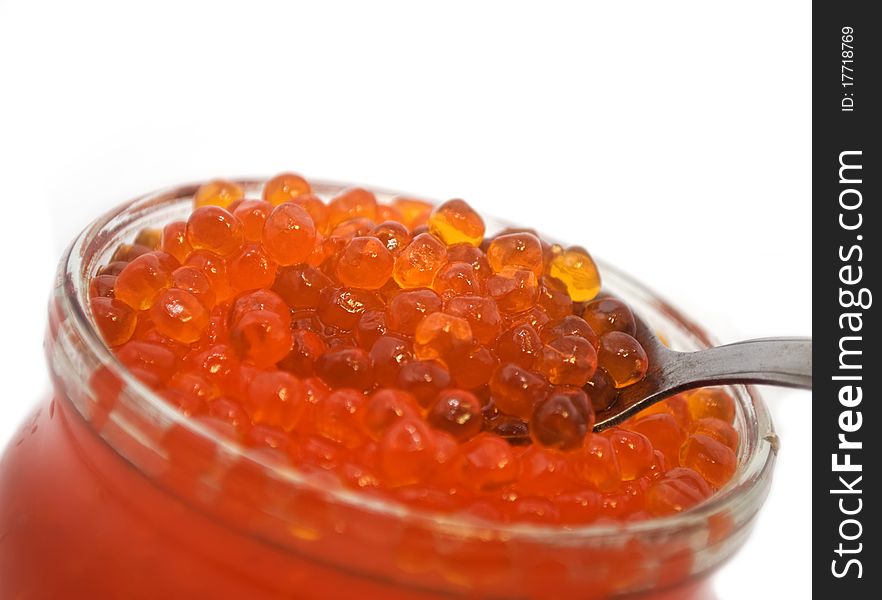 Red caviar in a spoon, salmon caviar, it is isolated on white