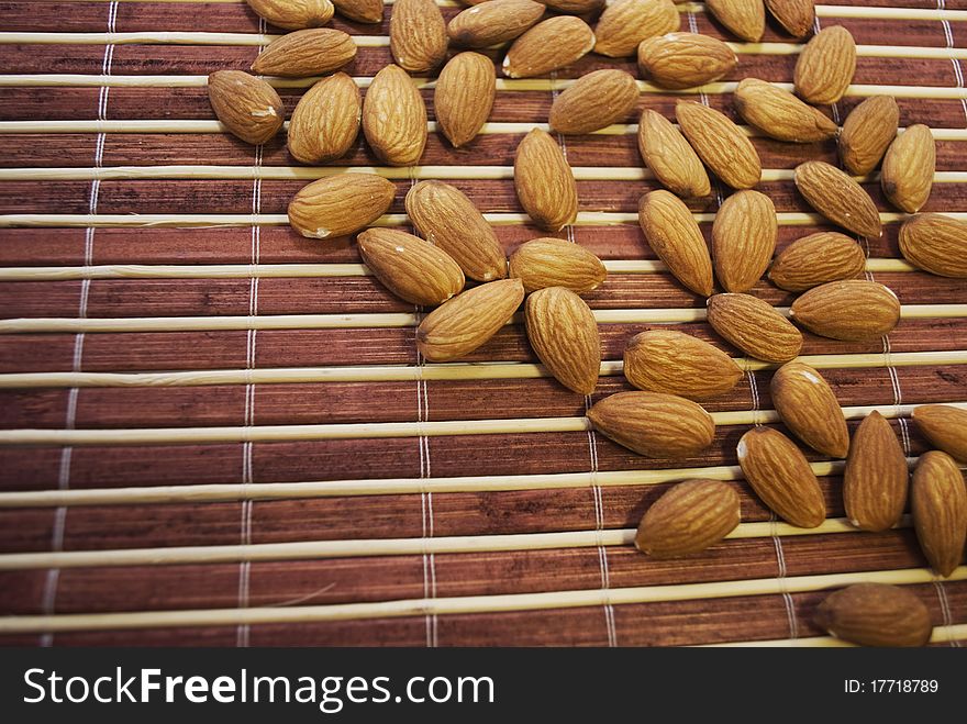 almonds handful on a bamboo laying. almonds handful on a bamboo laying