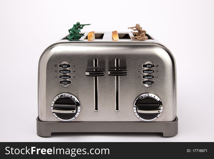 A toaster used as trenches for toy soldiers. A toaster used as trenches for toy soldiers