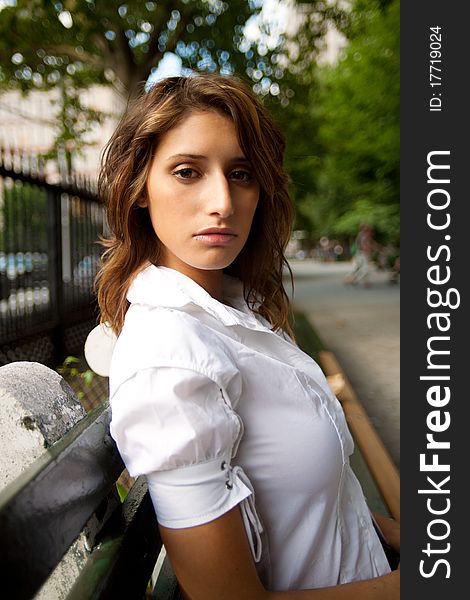 Female sitting on a bench in the park. Female sitting on a bench in the park