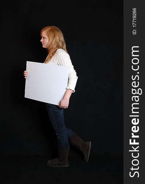 Woman carrying blank white placard sign. Woman carrying blank white placard sign.