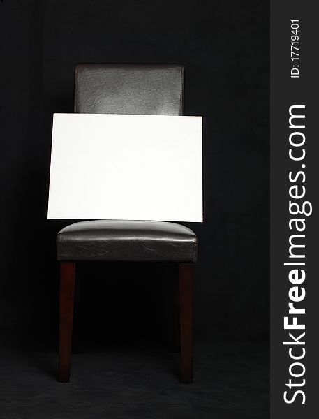 Black parson's chair with white blank sign. Black parson's chair with white blank sign