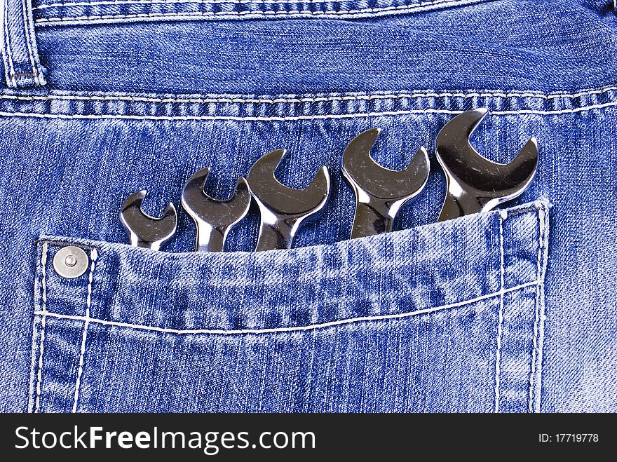 Five wrenches in a blue jeans pocket. Five wrenches in a blue jeans pocket