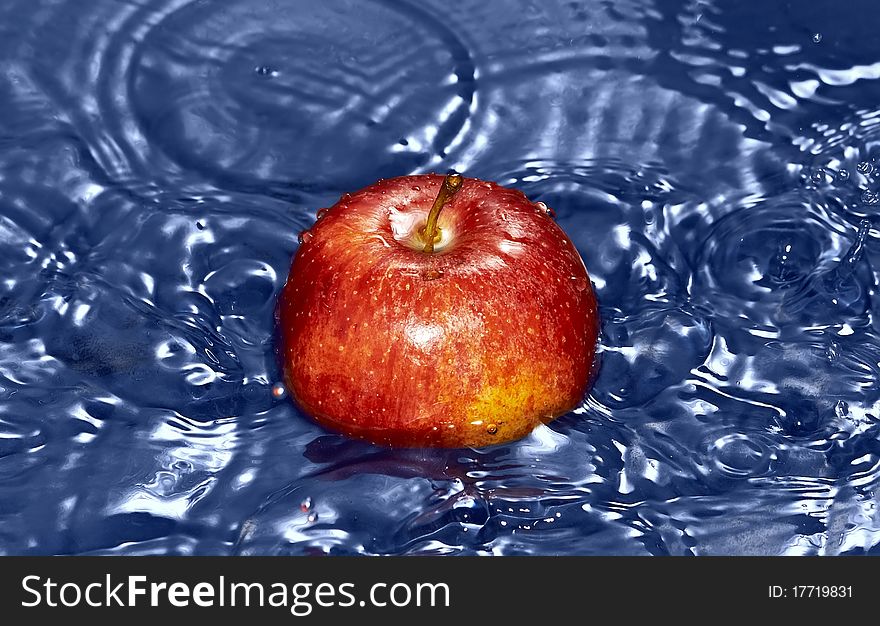 Red Apple in water with splash
