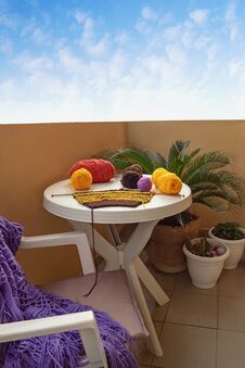 Spending Time At Home. Balls Of Wool And Unfinished Knitting On Table On Balcony Stock Images