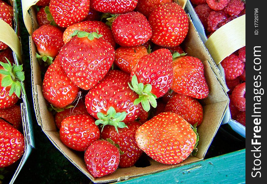 Strawberry in a market with raspberry