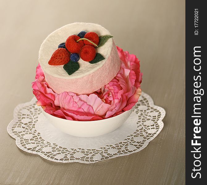 Decorative pink flower and little hat on the table. Decorative pink flower and little hat on the table