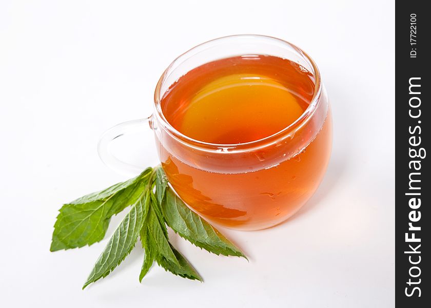 Glass cup of fresh tea with mint leaves